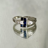 white gold diamond and synthetic sapphire arched ring