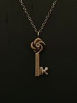 gold love knot key necklace