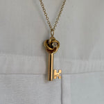 gold love knot key necklace