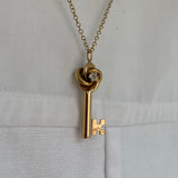 gold love knot key necklace