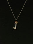 gold love knot key necklace